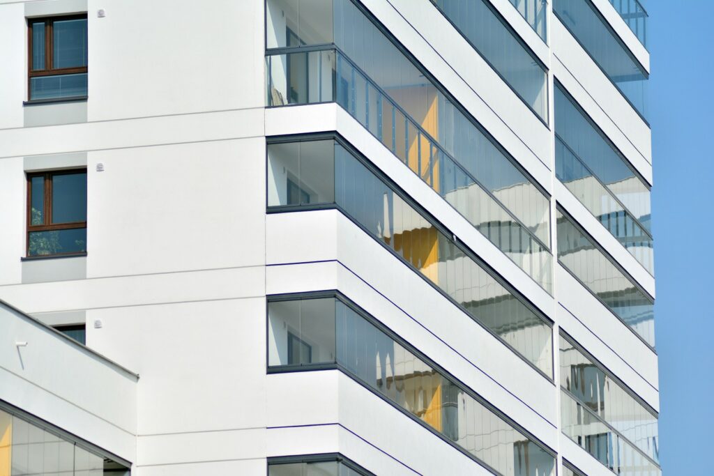 Facciata di un condominio moderno con terrazze vetrate e linee architettoniche pulite
